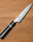 Knife with a black handle on a wooden surface