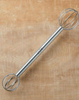 Metal miso whisk on a wooden surface