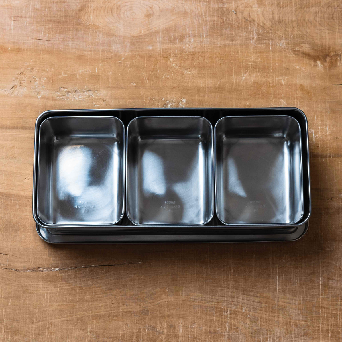 A common kitchen smallware for prepping a work station Stainless Mise en Place containers 