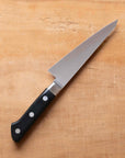 Knife with a black handle on a wooden surface