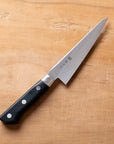 Knife with a black handle on a wooden surface